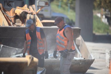 DNIPRO, UKRAINE - 08.24.20: bir Rus roketi Dnipro otobüs durağına çarptı. Otobüs durağı, dükkanlar ve ticaret kulübeleri yıkıldı. İşçiler hasarı temizler