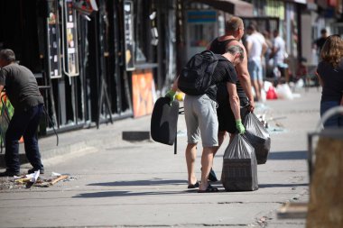 DNIPRO, UKRAINE - 08.24.20: bir Rus roketi Dnipro otobüs durağına çarptı. Otobüs durağı, dükkanlar ve ticaret kulübeleri yıkıldı. İşçiler hasarı temizler