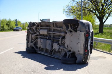 Trafik kazası. Araba devrildi. Araba çatıya yuvarlandı. Tekerlek çıktı. Kırık minibüs. Ters dönmüş minibüs.