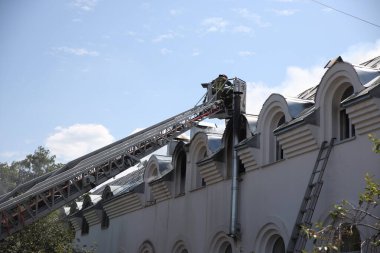 Fire in the church temple. The church cathedral is on fire. Heavy smoke in the temple area. The roof of the cathedral caught fire. Fire in the church. clipart