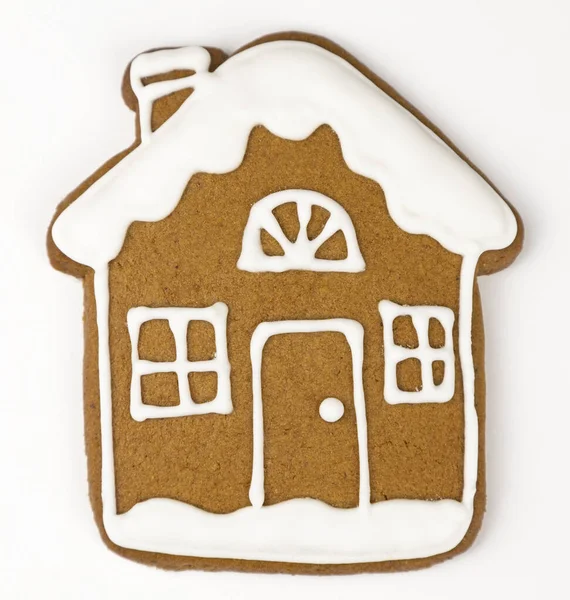 stock image Gingerbread in the form of a house with white icing on a white background