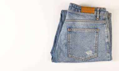 Blue jeans lie on a white background, denim texture