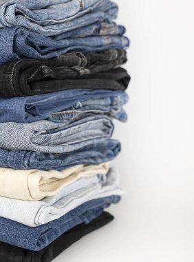 Denim pants stack on white background. Shopping concept
