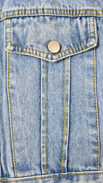 A close-up of a denim jacket pocket. Denim texture background