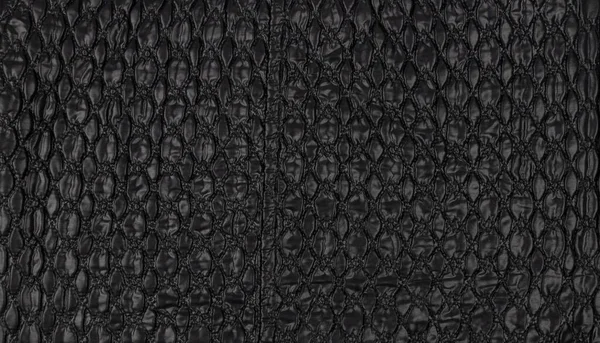 A pattern on a black leather surface. Black leather texture background