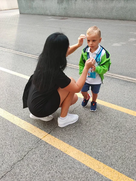 a small child came to school for the first time, together with his mother. first day of school