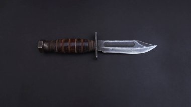        American combat knife, on a black background                         
