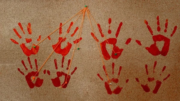 Red, bloody handprints on a cork board. An orange thread is drawn on each of the prints. Concepcin : The Maniac stand