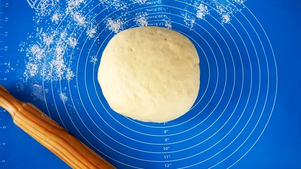dough on a blue silicone mat
