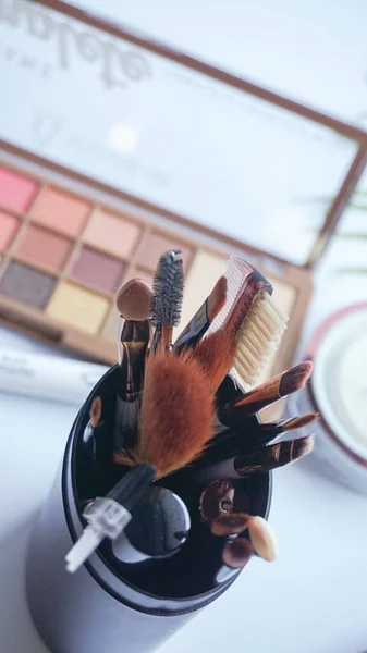Set of make-up brushes. Set of clean black vector professional makeup concealer powder blush eye shadow eyebrow brush with black handles and makeup palette.