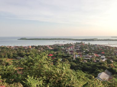 Aerial view of the sea from the top of the mountain and village in the evening.