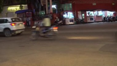 JAIPUR, INDIA - 10 AĞUSTOS 2019: Vibrant cadde trafiği Jaipur, Hindistan 'da gece vakti popüler bir pazarın önünden geçiyor