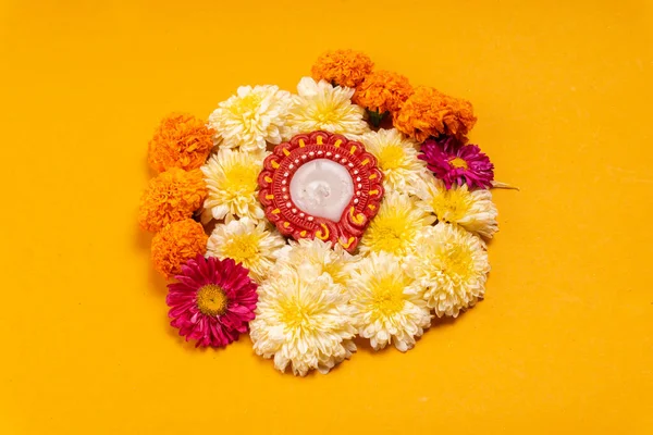 stock image close-up view of beautiful flowers with candle on yellow background