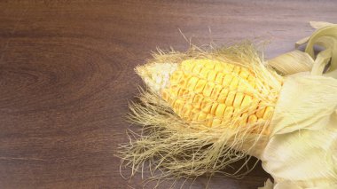 raw corn head on wooden background