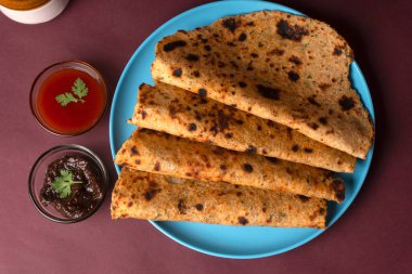 Healthy Indian Mooli or Radish paratha or stuffed flatbread with coriander and green chilli chutney