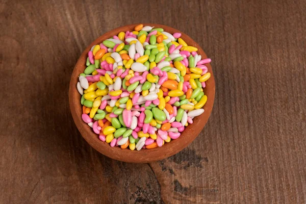 colorful candies in bowl on the wooden table