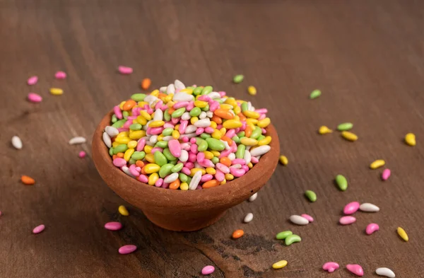 colorful candies in bowl on the wooden table