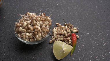close up view of raw sprouted soy in bowl, healthy food concept