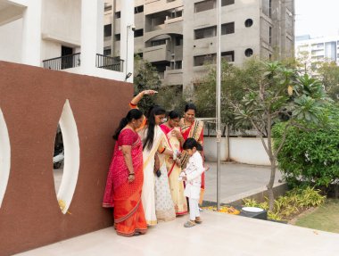 PUNE, MAHARASHTRA, INDIA, JANUARY - 26, 2023: Unidentified people celebrating the India Republic day with flag in society of city. Independence Day or Republic Day concept.