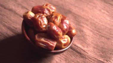 dried dates in bowl on the wooden table