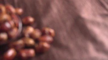 blurred footage of dried dates in bowl on the wooden table