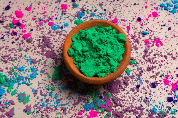 Green powder for holi in clay pot on occasion of indian festival of colors.