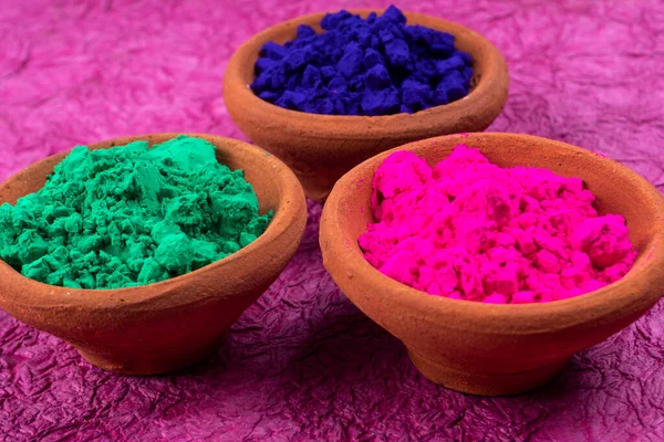 Colorful powders for holi in clay pots on occasion of indian festival of colors. happy holi theme.