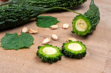 fresh green momordica charantia or bitter melon on wooden surface