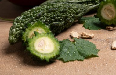 fresh green momordica charantia or bitter melon on wooden surface