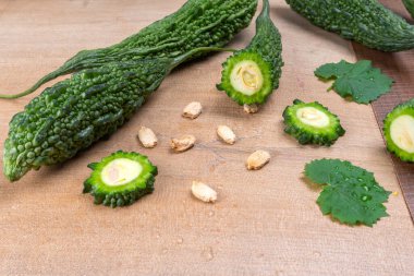 fresh green momordica charantia or bitter melon on wooden surface