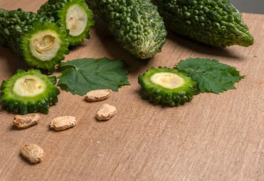 fresh green momordica charantia or bitter melon on wooden surface
