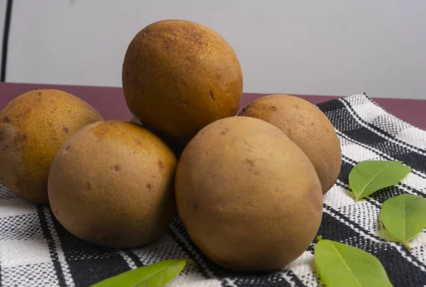 stock image Sapodilla fruit (Manilkara zapota) and other names such as sapota, chikoo, chico, naseberry, or nispero. Sapodilla is tropical fruit evergreen tree and sweet taste fruit.