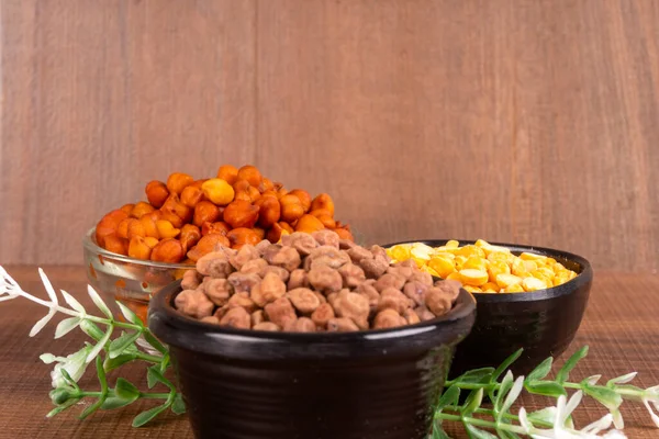 stock image bowl of chickpeas and dried corn on wooden background