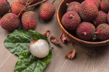 Tahta arka planda taze liçi meyveleri