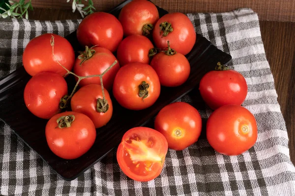 stock image Fresh red tomatoes with water drops on a dark background. Harvesting tomatoes. Top view