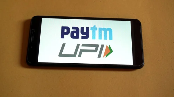 stock image mobile phone with paytm service on screen