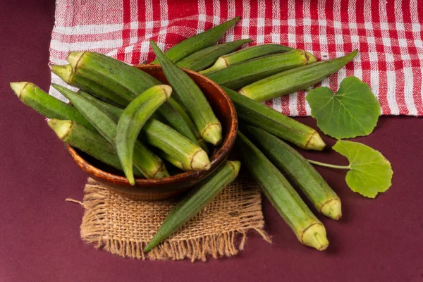 Stock image fresh green indian okra on purple background