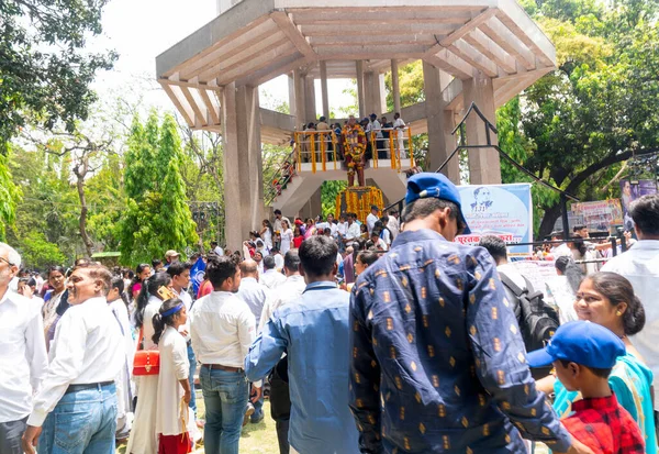 stock image Pune,India - 14 April 2022 : People garland and pay respect to Dr. B.R. Ambedkar, who wrote Indian constitution, statute on 131 anniversary celebrations.