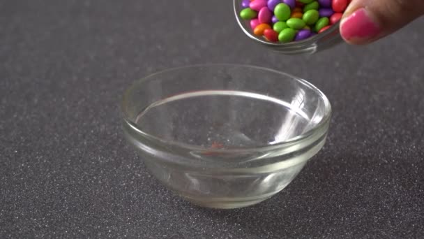 Female Hand Pouring Colorful Tiny Candies Bowl — Stock Video