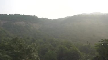 PUNE, MAHARASHTRA, Hindistan 12 AĞUSTOS 2023: Gün batımında ormanlı güzel dağ manzarası 
