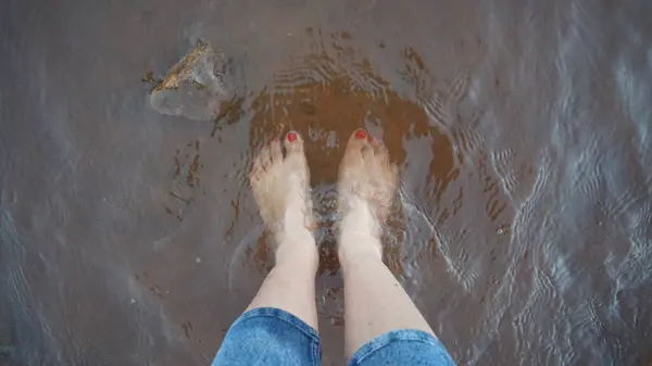 woman feet in water