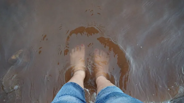 woman feet in water