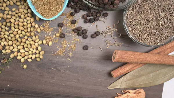 Indian Spices and herbs on wooden background. Food and cuisine ingredients