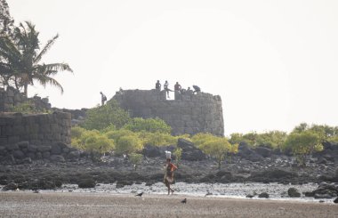 ALIBAG, MAHARASHTRA, INDIA - 25 March 2024 : Unidentified tourist at Alibag beach near Kolaba Fort in morning. clipart