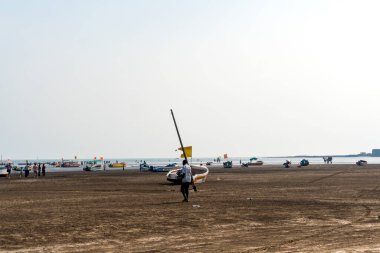 ALIBAG, MAHARASHTRA, INDIA - 25 Mart 2024: Kolaba Kalesi yakınlarındaki Alibag plajında kimliği belirsiz turist.