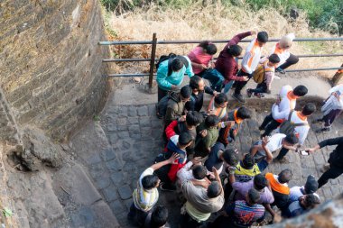 Pune, Maharashtra, India - December 10 2023: Tourists visiting Sinhagad fort (Kondhana Killa) near Pune. Sinhagad is an ancient hill fortress located at around 49 km southwest of the city of Pune. clipart