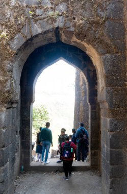 Pune, Maharashtra, India - December 10 2023: Tourists visiting Sinhagad fort (Kondhana Killa) near Pune. Sinhagad is an ancient hill fortress located at around 49 km southwest of the city of Pune. clipart