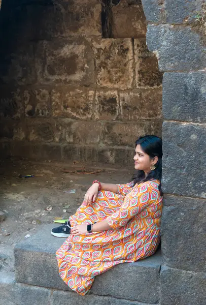 stock image Pune, Maharashtra, India - December 10 2023: Female tourist visiting Sinhagad fort (Kondhana Killa) near Pune. Sinhagad is an ancient hill fortress located at around 49 km southwest of the city of Pune.