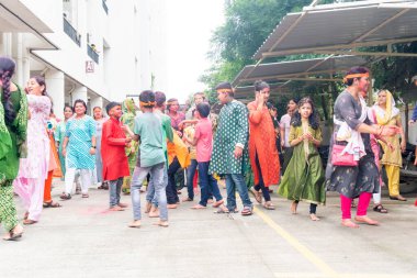 PUNE, MAHARASHTRA, INDIA - 8 EYLÜL 2022: Kimliği belirlenemeyen inançlı insanlar, su kaynaklarının yakınına dalmadan önce Hindu tanrısı Ganesha 'ya dua ediyorlar (Ganesh Chaturthi), yıllık festival