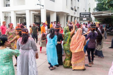 PUNE, MAHARASHTRA, INDIA - 8 EYLÜL 2022: Kimliği belirlenemeyen inançlı insanlar, su kaynaklarının yakınına dalmadan önce Hindu tanrısı Ganesha 'ya dua ediyorlar (Ganesh Chaturthi), yıllık festival